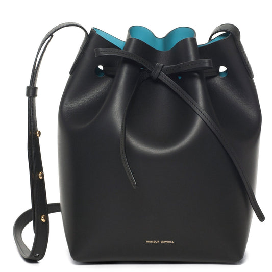 Italian vegetable tanned leather black mini bucket bag with sky blue matte patent interior.