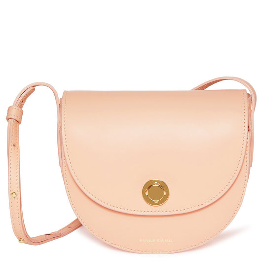 Italian calf leather light pink mini saddle bag with two interior pockets and beige canvas interior.