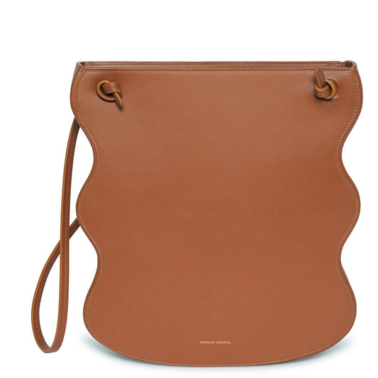 Italian calf leather saddle ocean bag with beige canvas interior and scalloped edge.